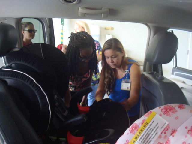 Child Passenger Safety Technician Month Certified Technicians show new parents how to properly install a car seat.